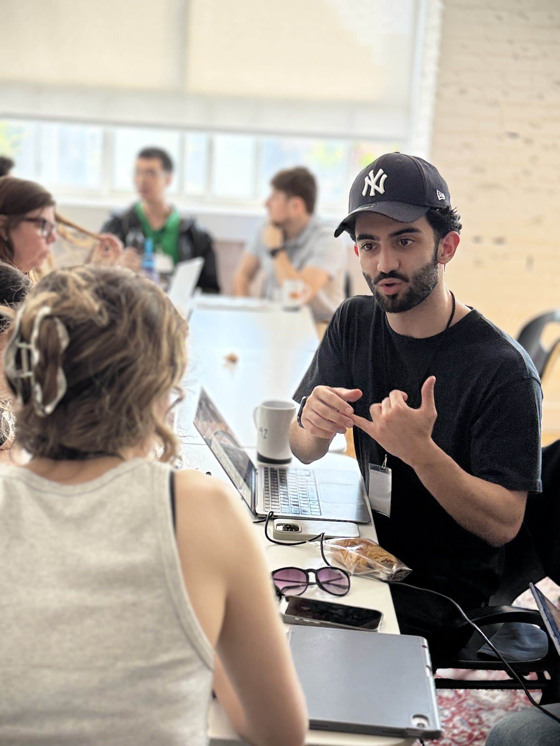 Mahyar talking with his team at the TMLS hackathon